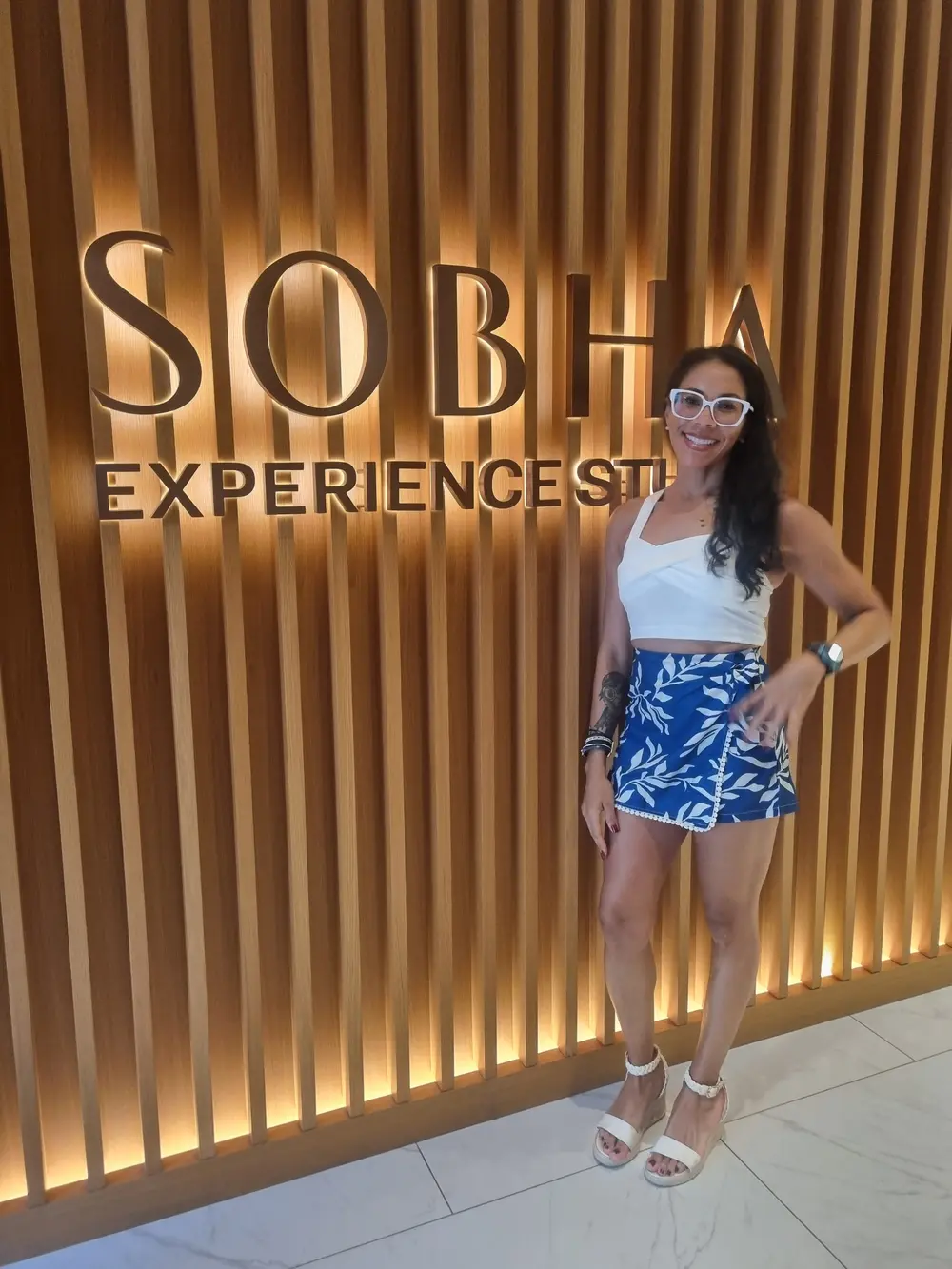 Lisa standing in a modern lobby