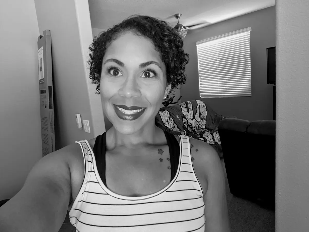 A candid black-and-white photograph of Lisa smiling at home